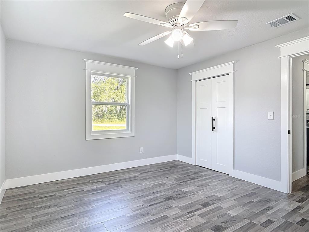 379 State Rte 415 Osteen, FL 32764 - Photo 34 of 48 wooden floor in an empty room with a window