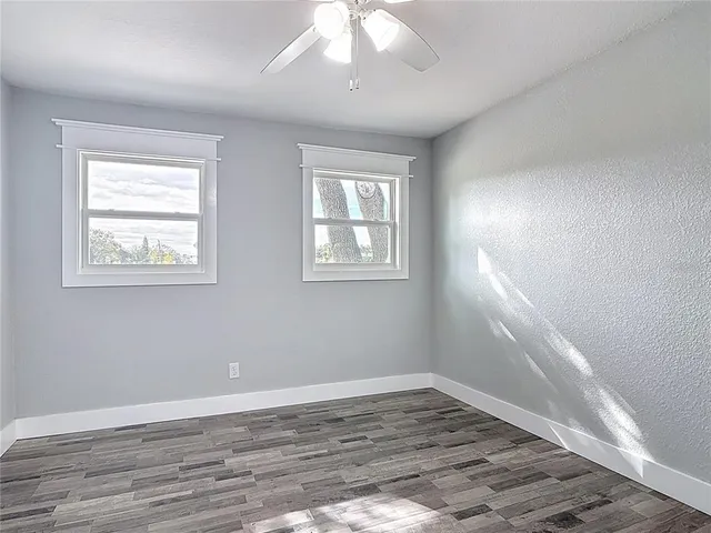 a bathroom with a granite countertop toilet sink and mirror