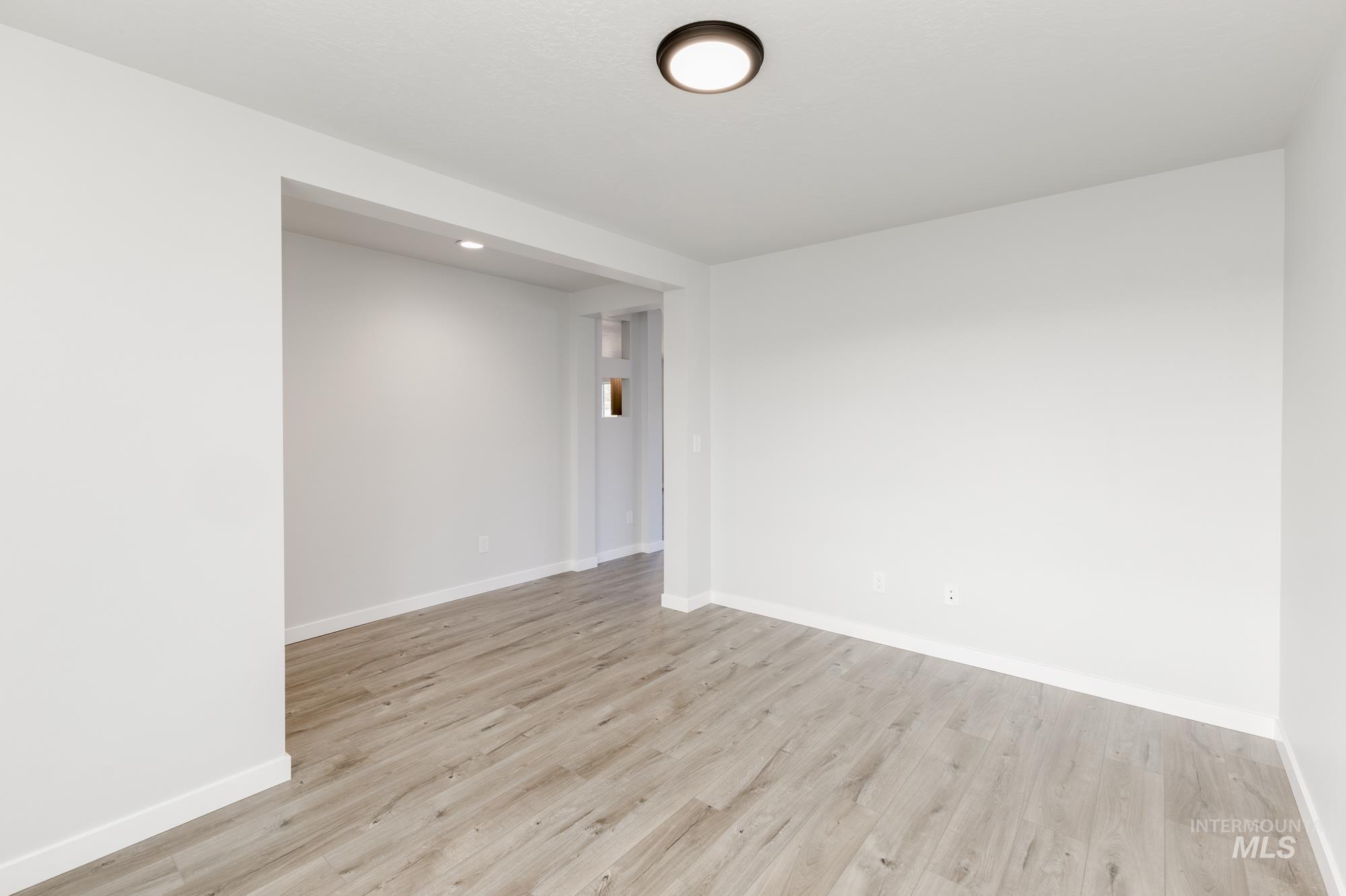 1702 Webb Brk Street Middleton, ID 83644 - Photo 11 of 21 Spare room with light wood-style floors and recessed lighting