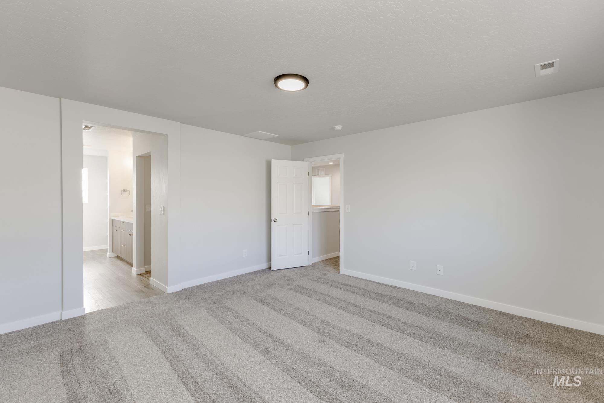 1702 Webb Brk Street Middleton, ID 83644 - Photo 18 of 21 Unfurnished bedroom with light carpet and ensuite bathroom