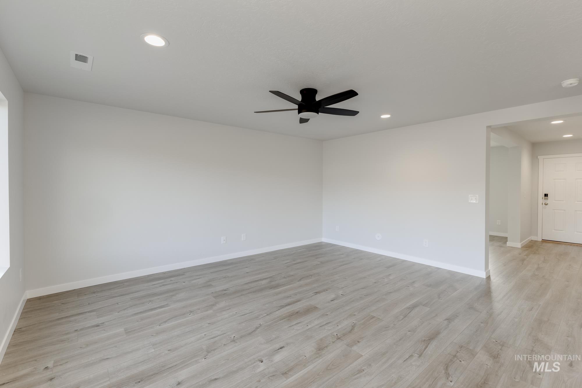 1702 Webb Brk Street Middleton, ID 83644 - Photo 8 of 21 Unfurnished room with light wood-type flooring, recessed lighting, and a ceiling fan
