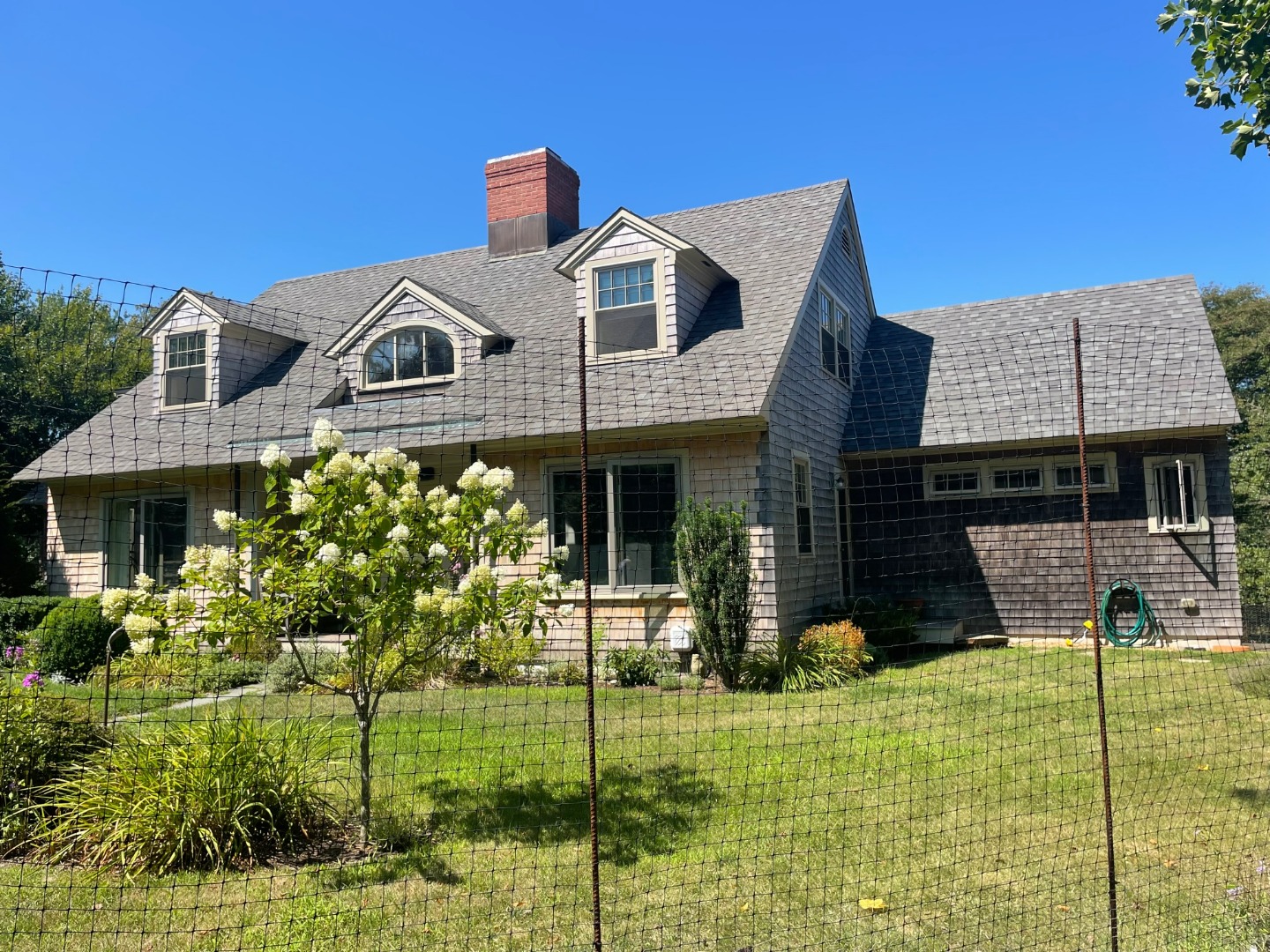 209 Chappaquiddick Road Edgartown, MA 02539 - Photo 3 of 7 a front view of a house with a garden