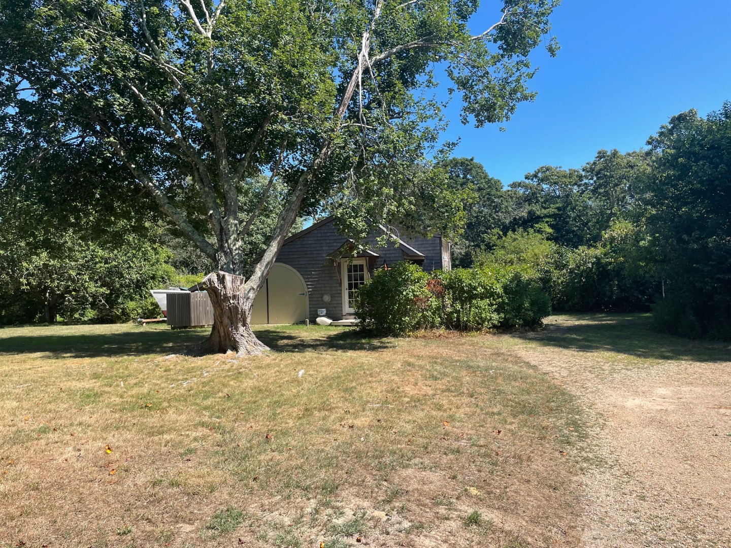 209 Chappaquiddick Road Edgartown, MA 02539 - Photo 5 of 7 a view of a wooden house with a yard