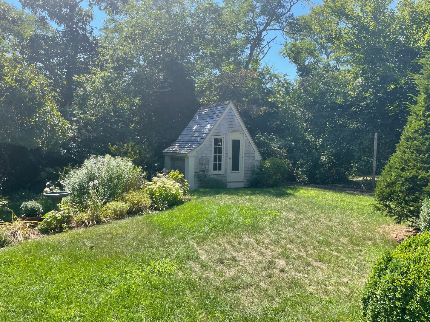 209 Chappaquiddick Road Edgartown, MA 02539 - Photo 6 of 7 a backyard of a house with lots of green space