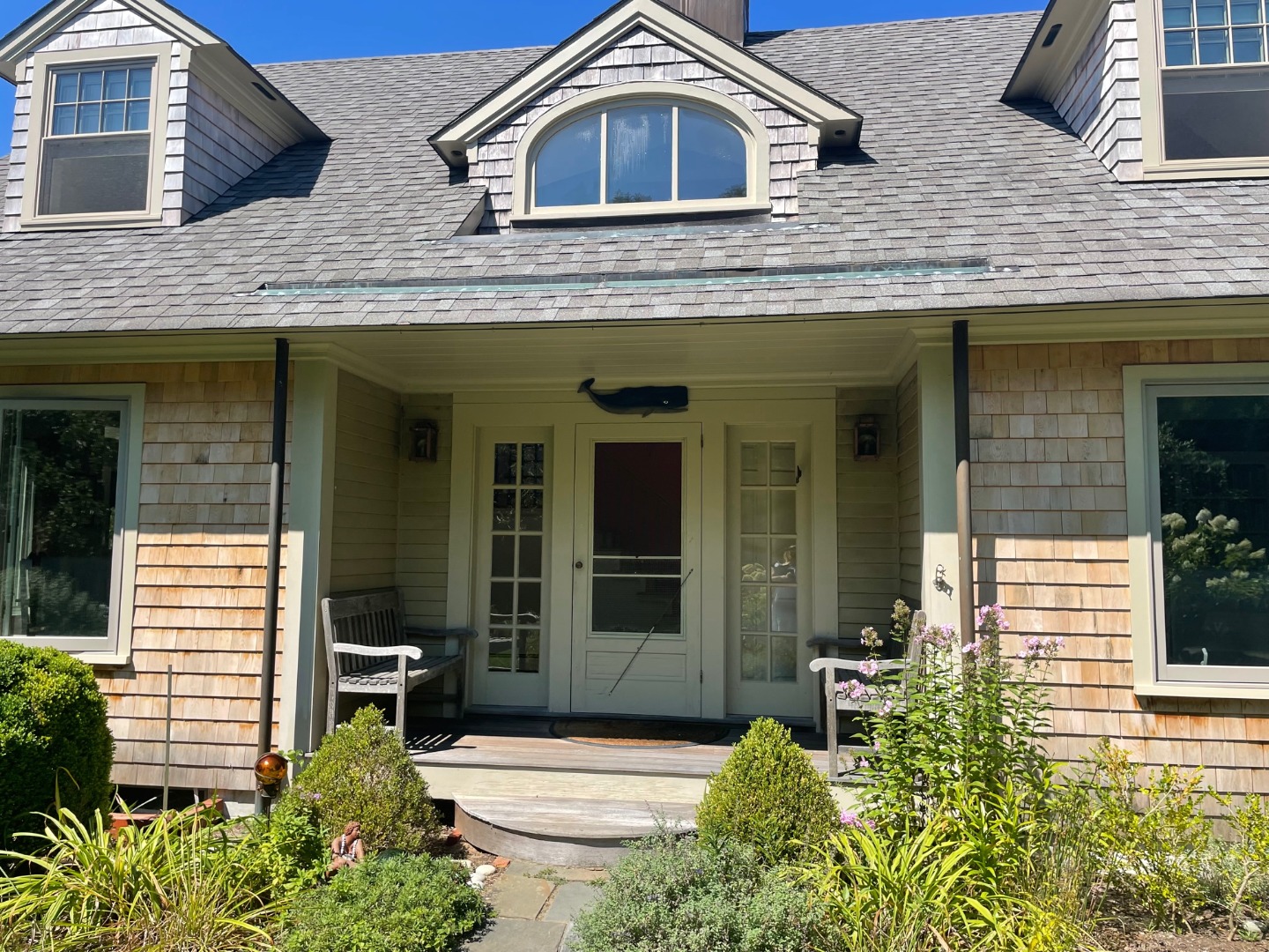 209 Chappaquiddick Road Edgartown, MA 02539 - Photo 7 of 7 a view of a brick house with large windows and a yard