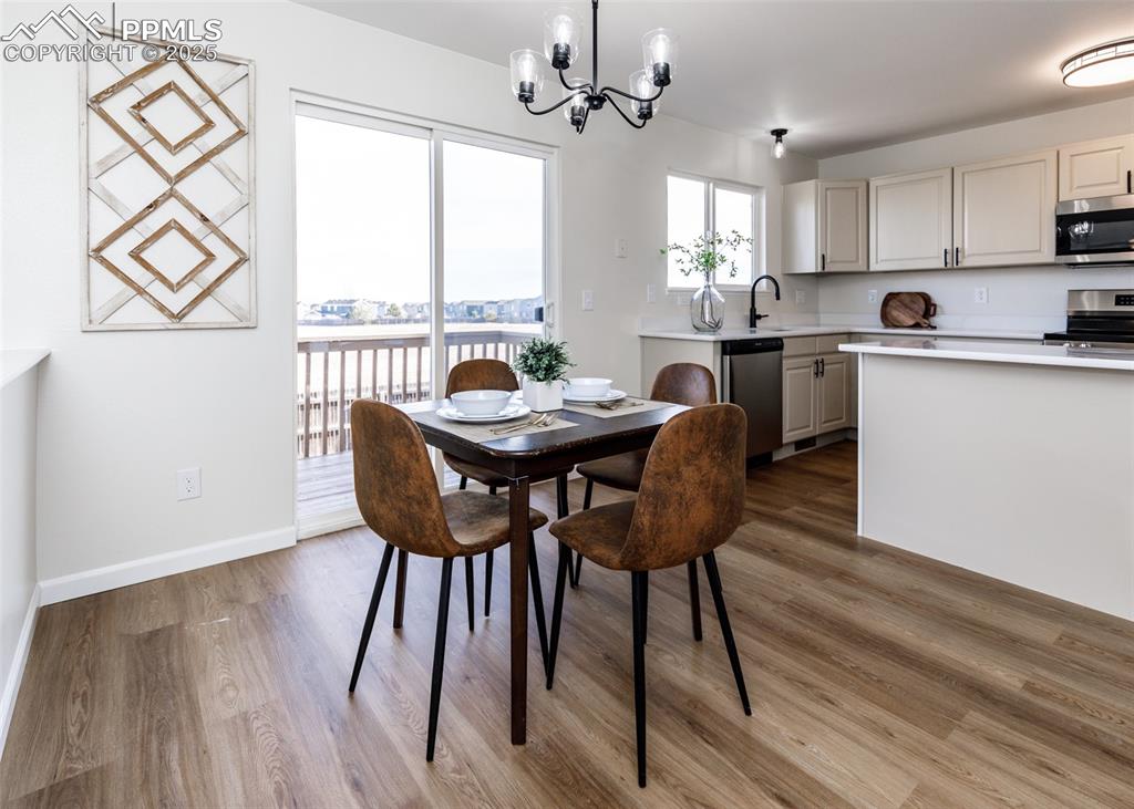 7715 Old Spec Road Peyton, CO 80831 - Photo 11 of 50 a view of a dining room with furniture window and wooden floor