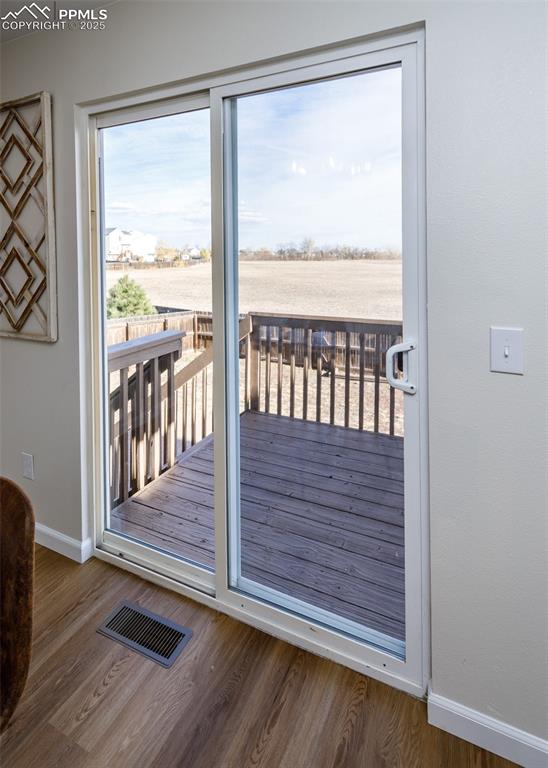 7715 Old Spec Road Peyton, CO 80831 - Photo 12 of 50 a view of a porch with wooden floor and a floor to ceiling window