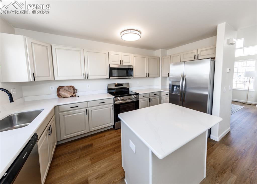 7715 Old Spec Road Peyton, CO 80831 - Photo 17 of 50 a kitchen that has a lot of white cabinets and stainless steel appliances