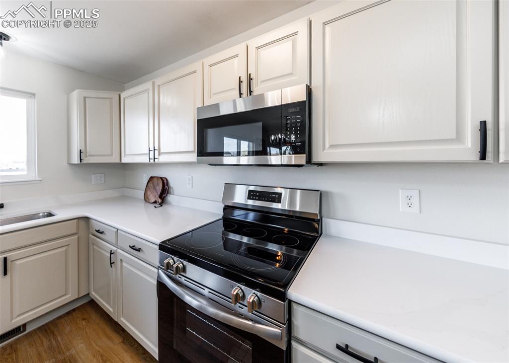 7715 Old Spec Road Peyton, CO 80831 - Photo 18 of 50 a kitchen with a sink a stove and cabinets