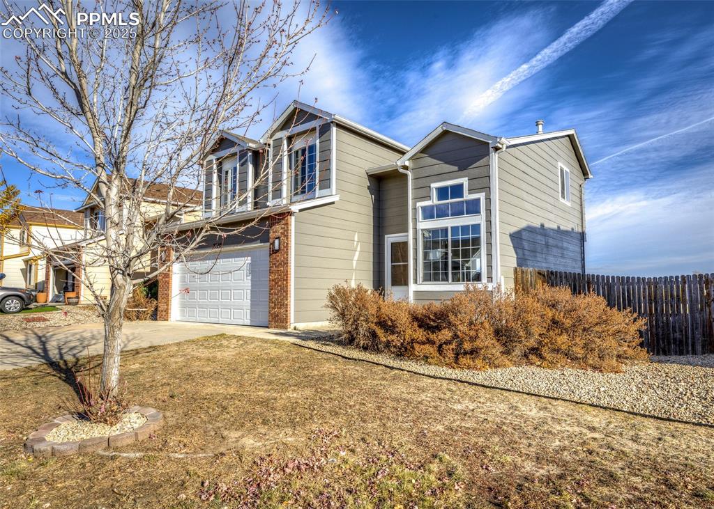 7715 Old Spec Road Peyton, CO 80831 - Photo 2 of 50 a front view of a house with garden