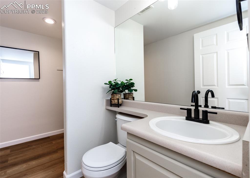 7715 Old Spec Road Peyton, CO 80831 - Photo 23 of 50 a bathroom with a sink a toilet and a mirror