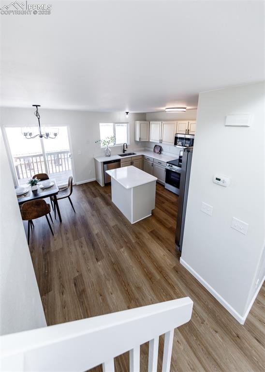 7715 Old Spec Road Peyton, CO 80831 - Photo 25 of 50 a living room with chairs and wooden floor