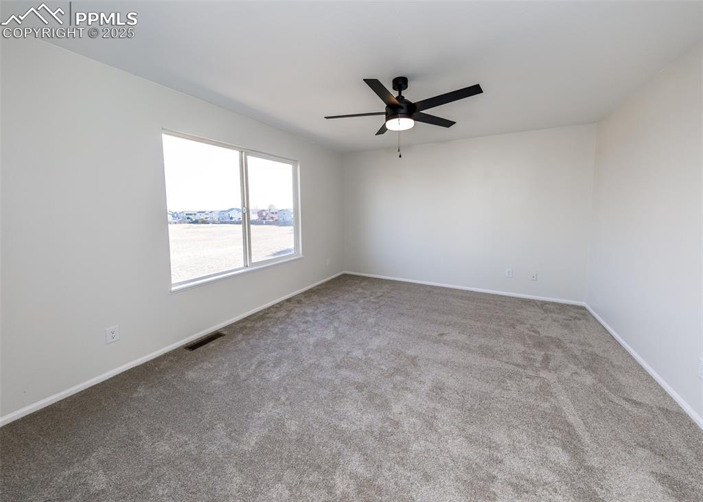 7715 Old Spec Road Peyton, CO 80831 - Photo 28 of 50 an empty room with a window and a fan