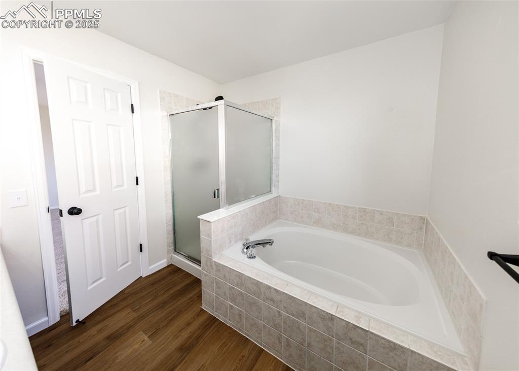 7715 Old Spec Road Peyton, CO 80831 - Photo 30 of 50 a bathroom with a bathtub and shower