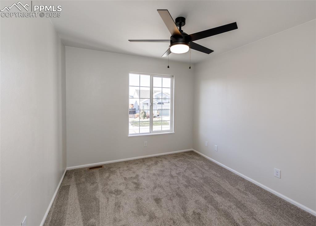 7715 Old Spec Road Peyton, CO 80831 - Photo 31 of 50 an empty room with a window and a fan