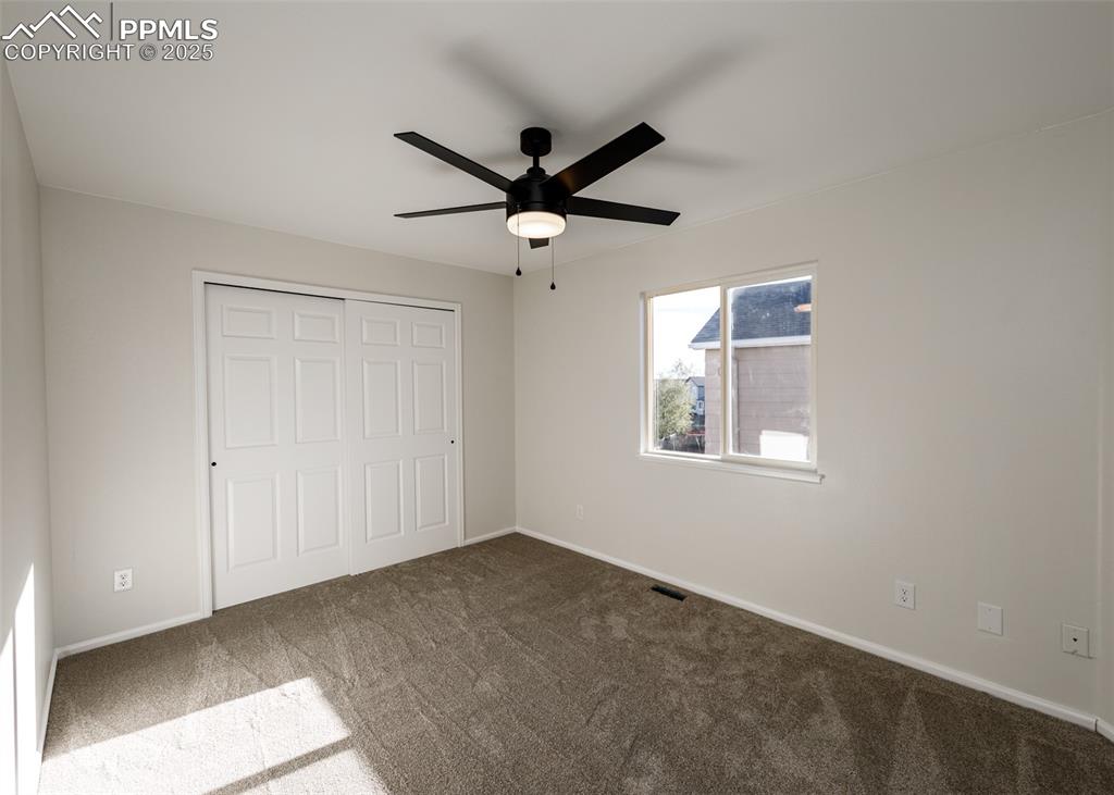 7715 Old Spec Road Peyton, CO 80831 - Photo 35 of 50 a view of a livingroom with a ceiling fan and window