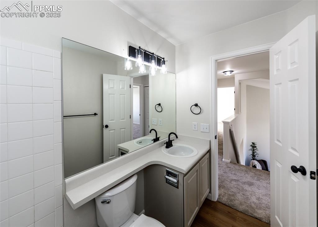 7715 Old Spec Road Peyton, CO 80831 - Photo 38 of 50 a bathroom with a sink a toilet and shower