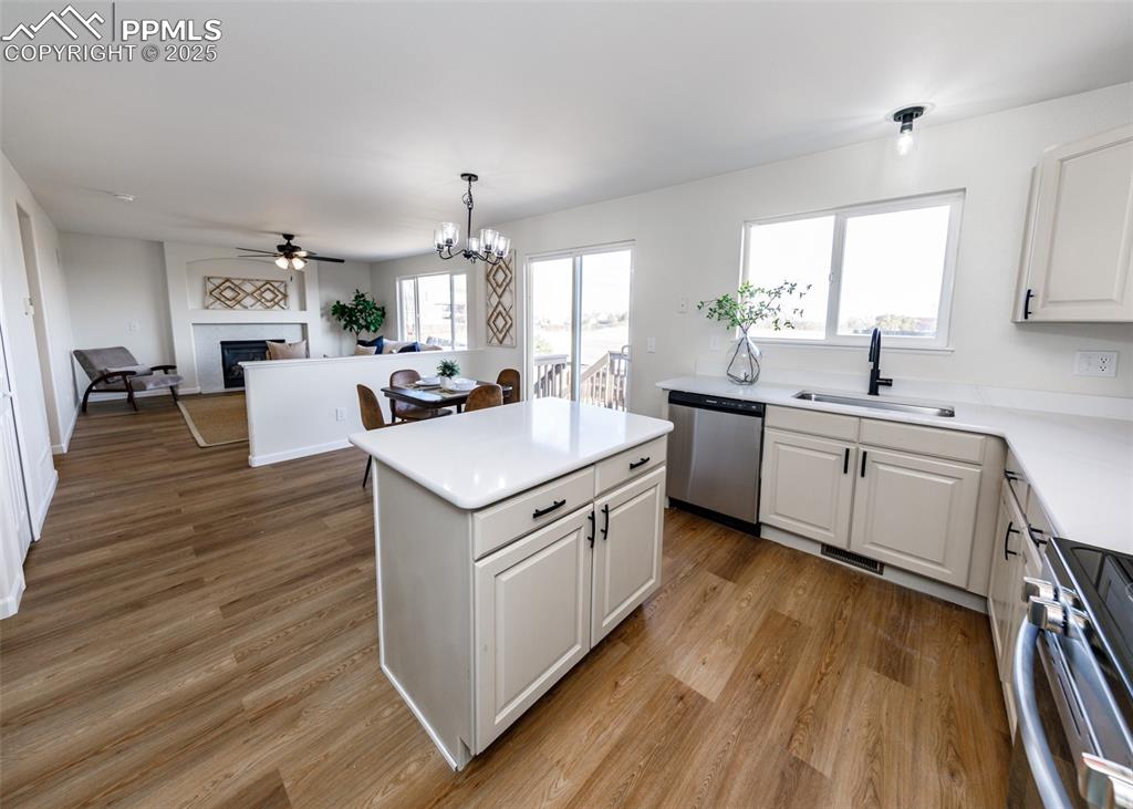 7715 Old Spec Road Peyton, CO 80831 - Photo 9 of 50 a kitchen with a sink stove cabinets and wooden floor