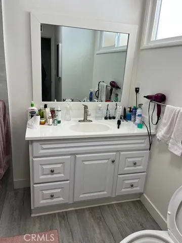 a bathroom with a sink a toilet and mirror