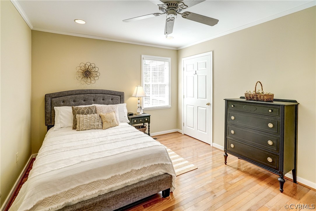 16381 Genito Road Moseley, VA 23120 - Photo 16 of 39 a bedroom with a bed and a chandelier