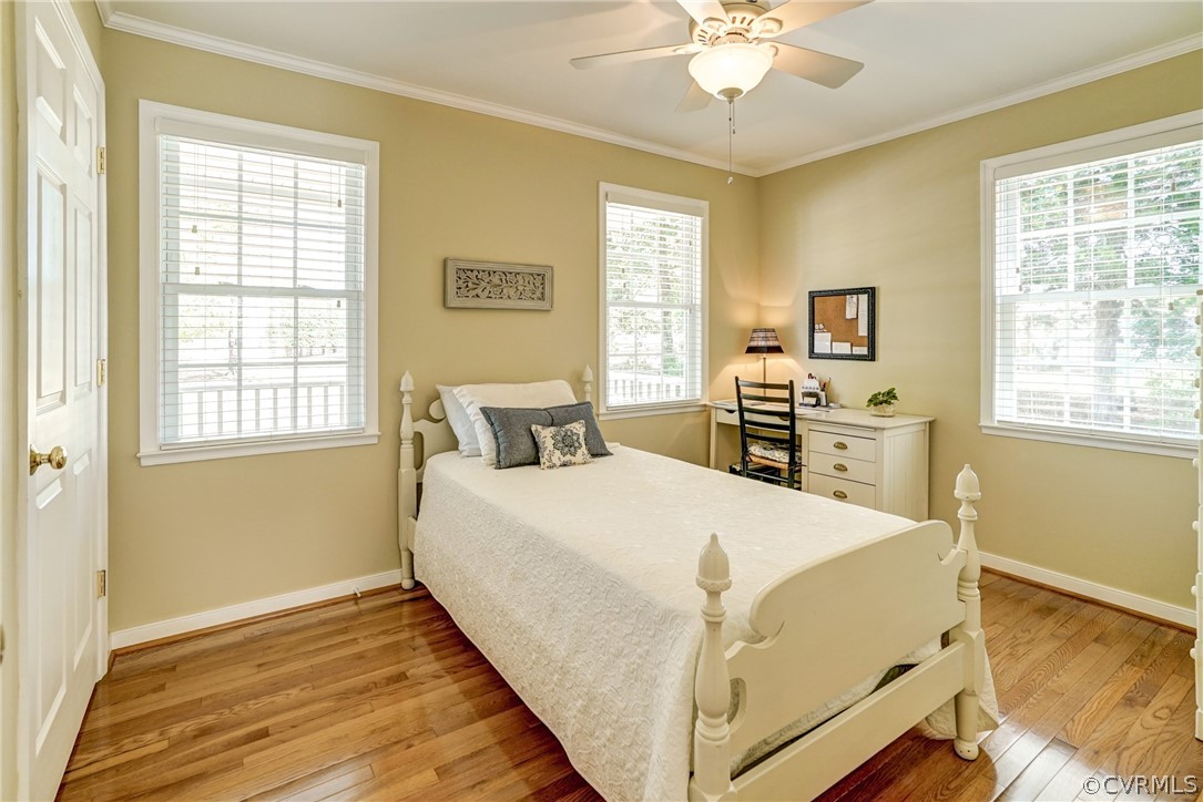 16381 Genito Road Moseley, VA 23120 - Photo 17 of 39 a living room with a bed and a table with wooden floor
