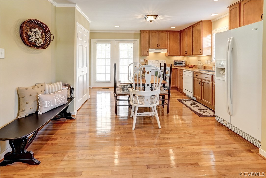 16381 Genito Road Moseley, VA 23120 - Photo 10 of 39 a dining room with stainless steel appliances a table chairs and a refrigerator