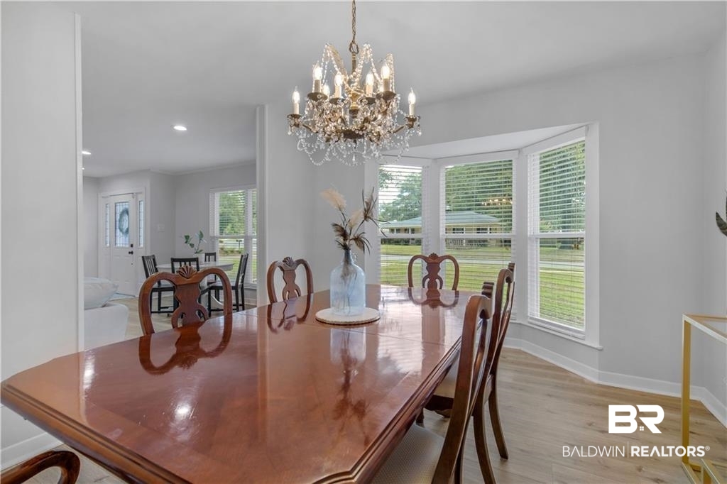 1624 Apex Drive Mobile, AL 36693 - Photo 18 of 29 Dining area with an inviting chandelier and light hardwood / wood-style floors