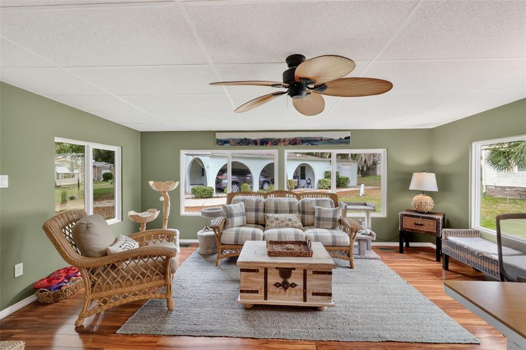 705 Devon Drive Lady Lake, FL 32159 - Photo 14 of 31 a living room with furniture and a chandelier