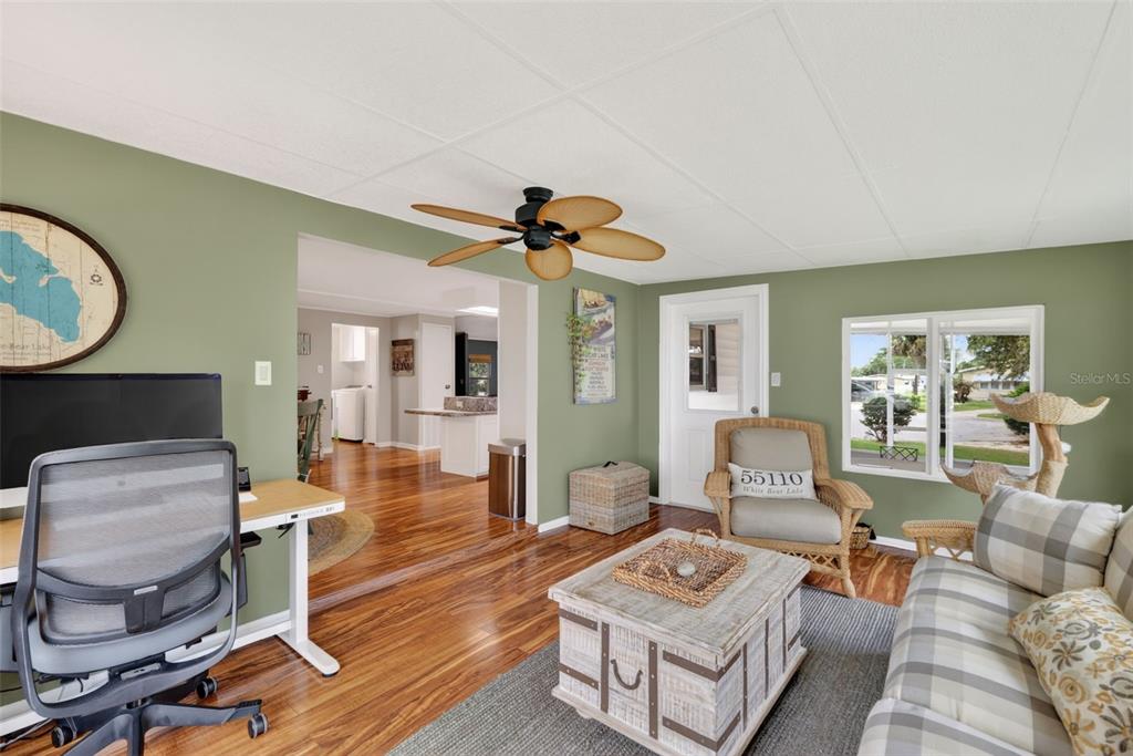 705 Devon Drive Lady Lake, FL 32159 - Photo 15 of 31 a living room with furniture and a wooden floor