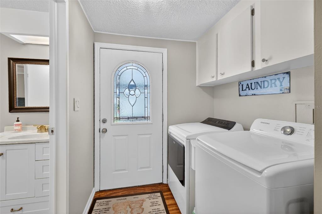705 Devon Drive Lady Lake, FL 32159 - Photo 18 of 31 a utility room with dryer and washer