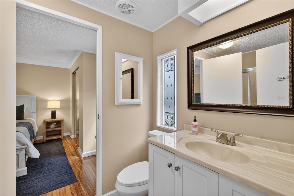 705 Devon Drive Lady Lake, FL 32159 - Photo 20 of 31 a bathroom with a granite countertop sink mirror and a toilet