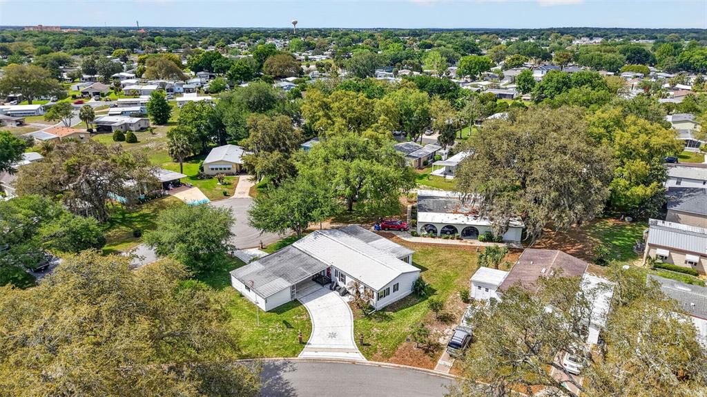 705 Devon Drive Lady Lake, FL 32159 - Photo 30 of 31 an aerial view of a house with yard swimming pool and outdoor seating