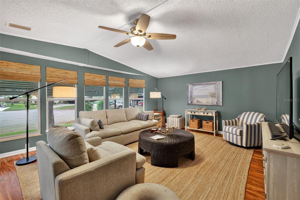 705 Devon Drive Lady Lake, FL 32159 - Photo 3 of 31 a living room with furniture and a large window
