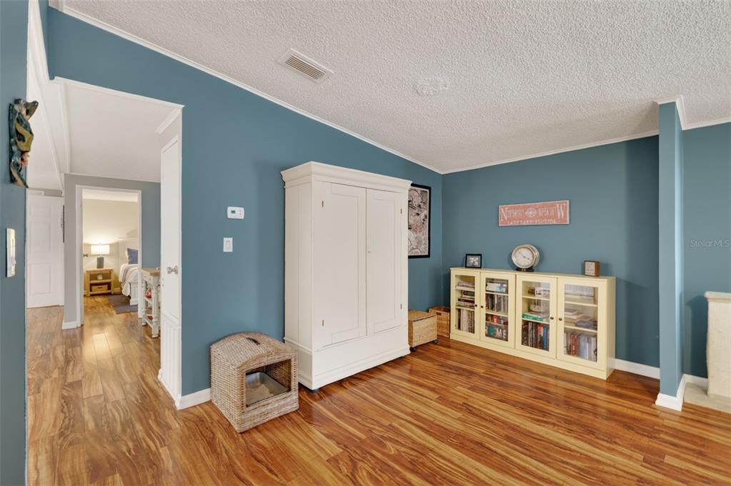 705 Devon Drive Lady Lake, FL 32159 - Photo 6 of 31 a view of a livingroom with wooden floor and furniture