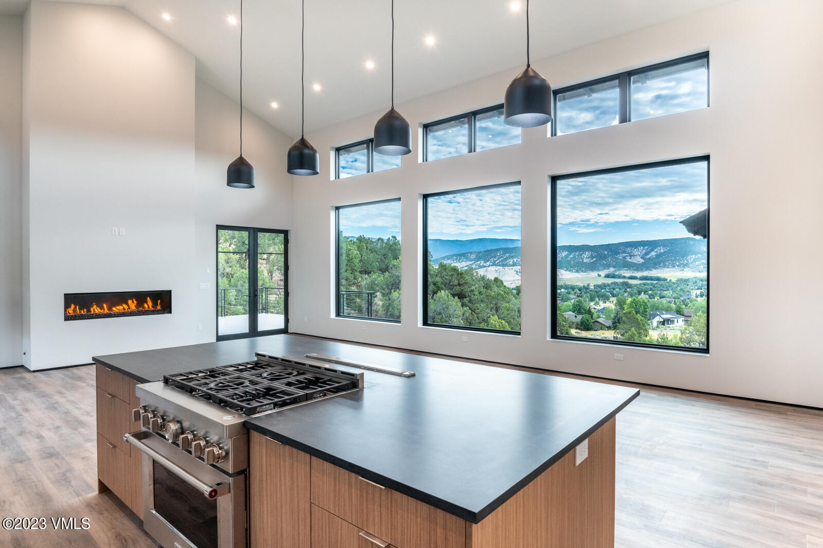 an open kitchen with a stove and a large window