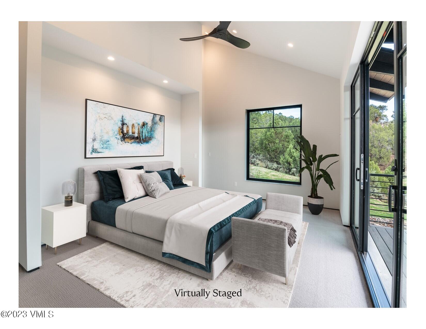 125 Silver Spur Eagle, CO 81631 - Photo 4 of 48 a spacious bedroom with a large bed and a painting on the wall