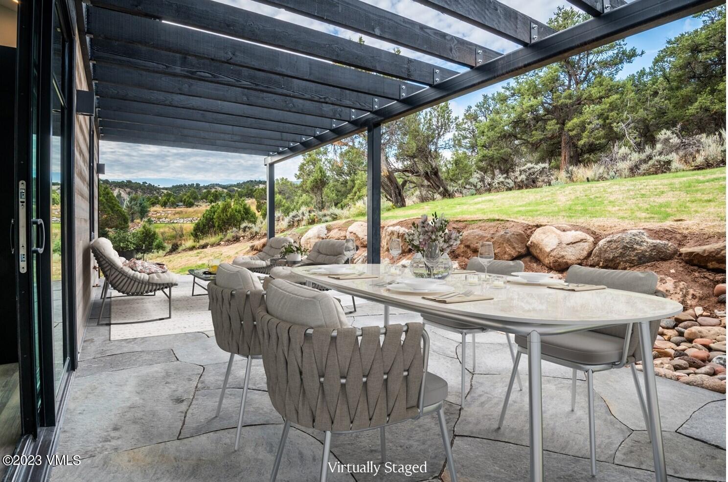 125 Silver Spur Eagle, CO 81631 - Photo 7 of 48 a view of an outdoor dining space with a table and chairs