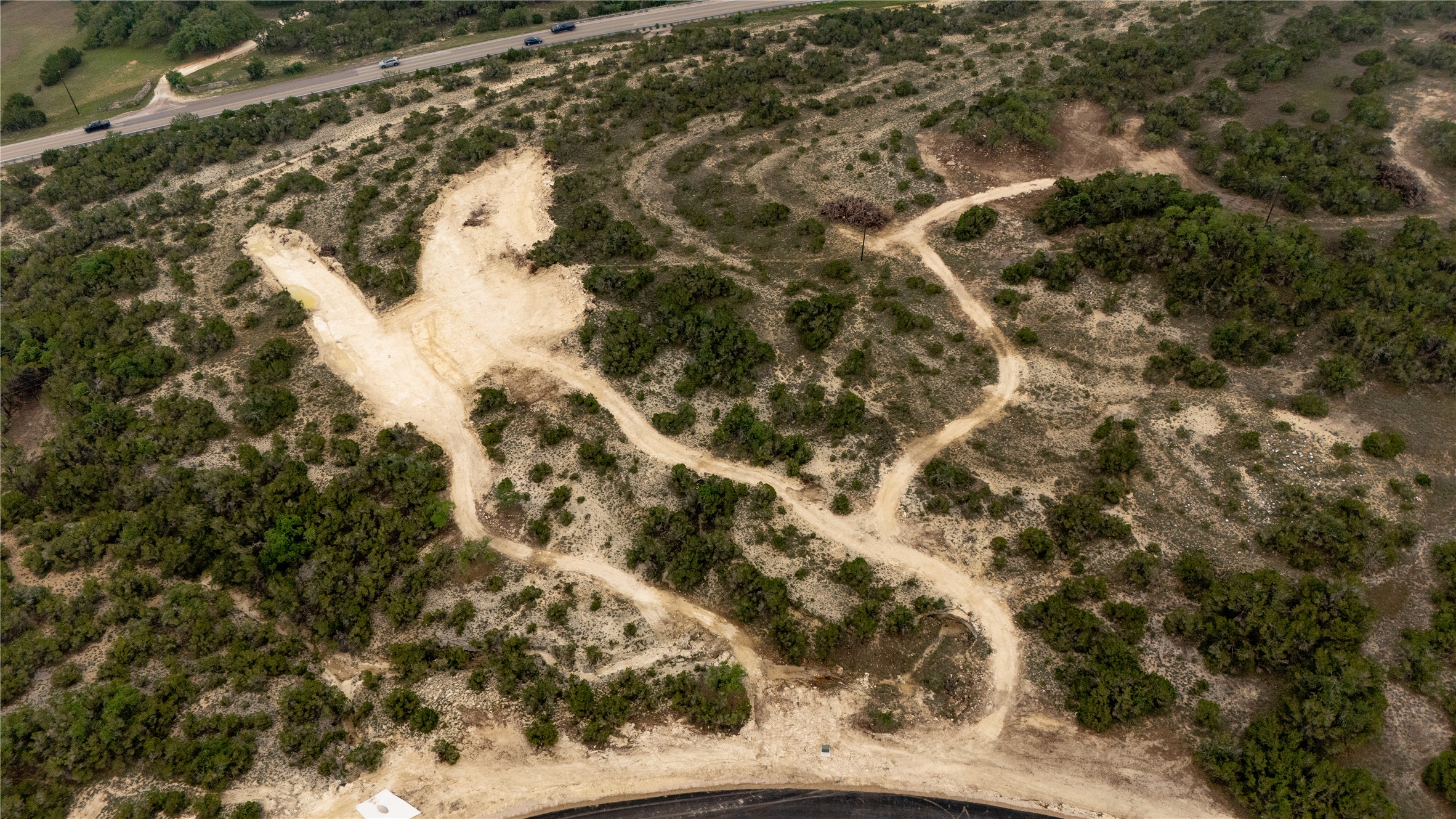 Lot 3 Ranch Road 165 Dripping Springs, TX 78620 - Photo 3 of 11 Expansive undeveloped land featuring natural terrain and sparse green foliage