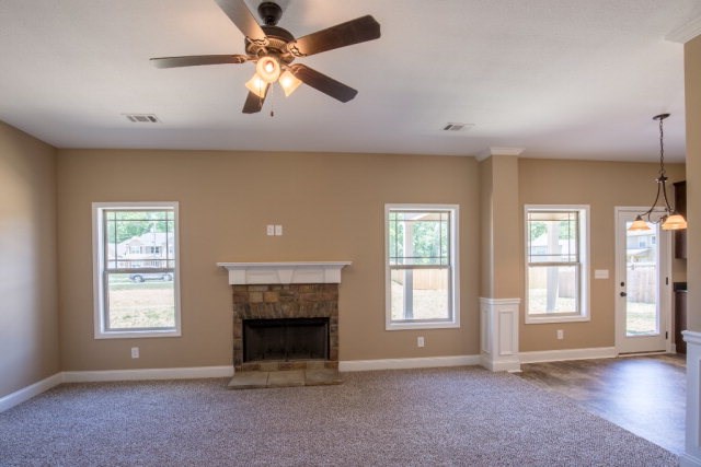 8 Fast Lane Fort Mitchell, undefined 36856 - Photo 11 of 44 an empty room with windows fireplace and a ceiling fan