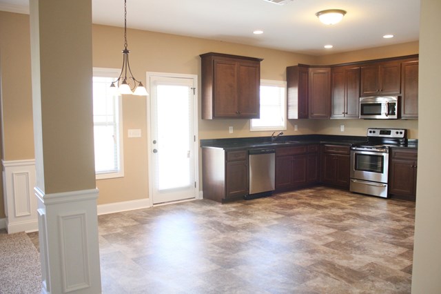 8 Fast Lane Fort Mitchell, undefined 36856 - Photo 13 of 44 a large kitchen with granite countertop a stove top oven sink and cabinets