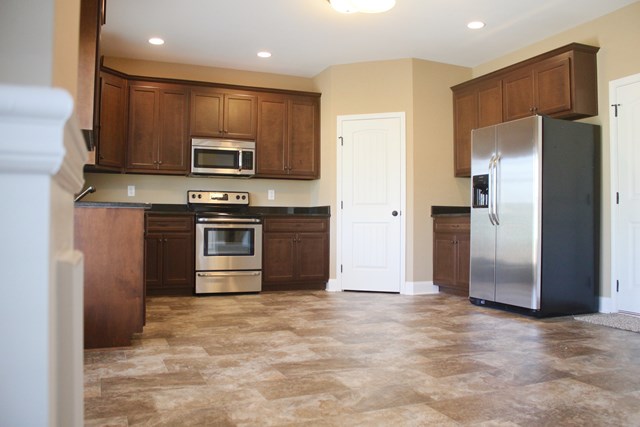8 Fast Lane Fort Mitchell, undefined 36856 - Photo 14 of 44 a kitchen with stainless steel appliances granite countertop a refrigerator a stove a sink and a microwave