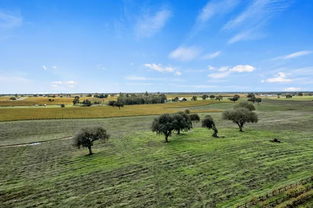 a view of a lake with outdoor space and trees all around