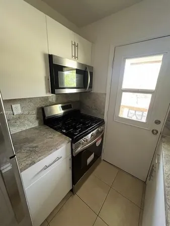 a kitchen with a stove and a microwave