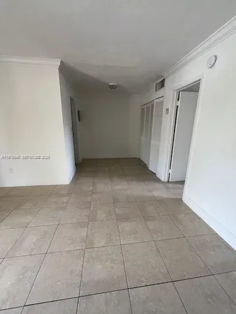 a view of a livingroom with an empty space and a window