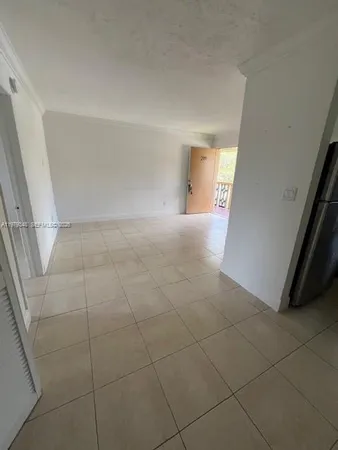 a view of an empty room and a window