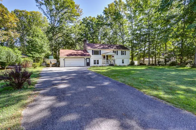 a front view of a house with a garden and trees