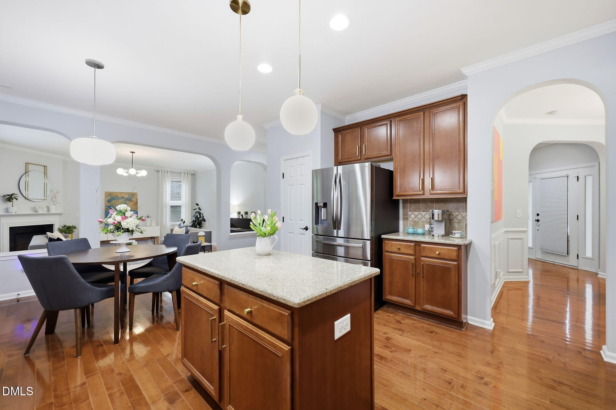 162 Gathering Place Durham, NC 27713 - Photo 10 of 52 a kitchen with stainless steel appliances granite countertop a stove refrigerator a dining table and chairs with wooden floor