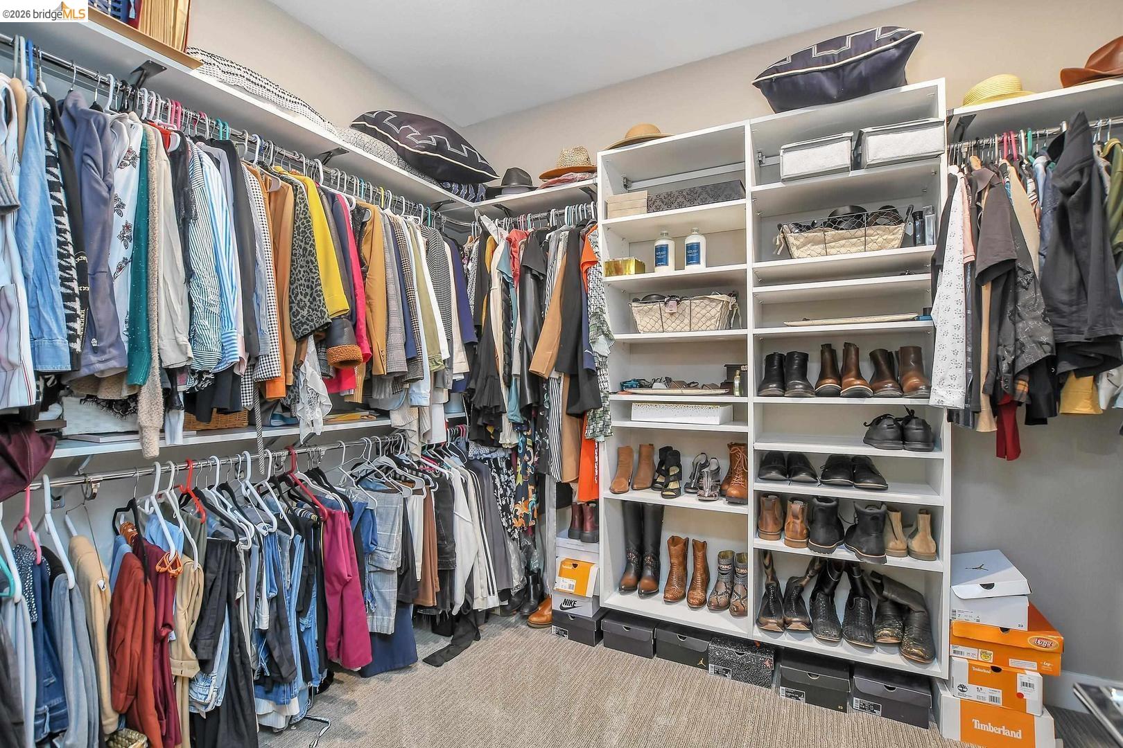 829 Hardcastle Ranch Road Oakley, CA 94561 - Photo 32 of 42 Walk-in closet featuring white shelving units, hanging rods, and carpet flooring
