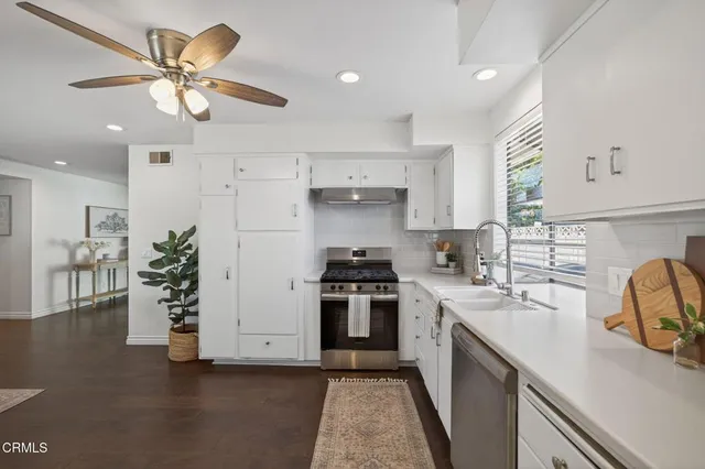 a kitchen with a sink stainless steel appliances and cabinets