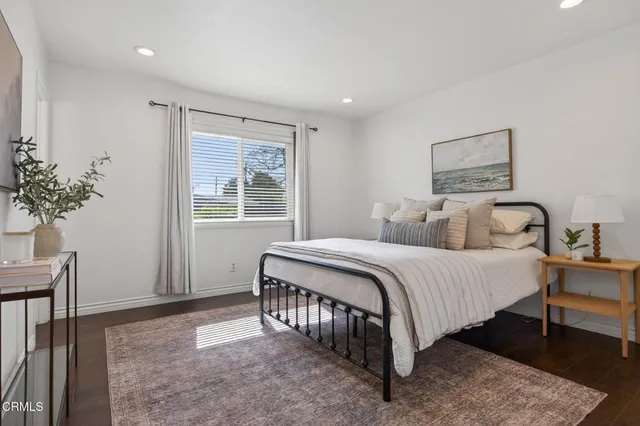 a spacious bedroom with a bed and a window